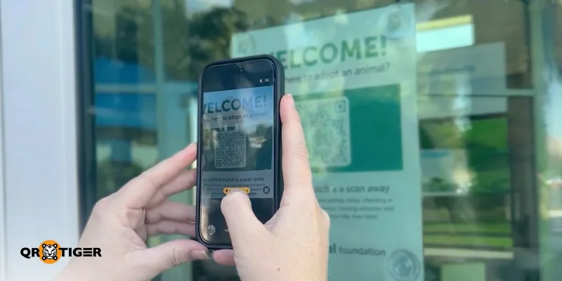 Visitor scanning the Animal Foundation QR code